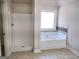 Bright bathroom showcasing a shower and a soaking tub near the window at 276 Arborview Dr, Mcdonough, GA 30252