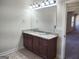 Bathroom featuring a double sink vanity with granite countertop and wood cabinets at 276 Arborview Dr, Mcdonough, GA 30252