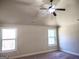 Neutral bedroom with vaulted ceiling, fan, carpet, and two windows for natural light at 276 Arborview Dr, Mcdonough, GA 30252