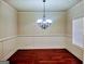 Dining room features hardwood floors, crown molding, and modern chandelier at 276 Arborview Dr, Mcdonough, GA 30252