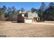 Side view of charming home, showing brick accents, side-entry garage and wooded lot at 276 Arborview Dr, Mcdonough, GA 30252