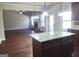 Open concept living room with hardwood floors and fireplace, viewed from kitchen island at 276 Arborview Dr, Mcdonough, GA 30252