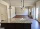 Open concept living room with hardwood floors and a fireplace, viewed from the kitchen at 276 Arborview Dr, Mcdonough, GA 30252