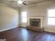 Cozy living room features a brick fireplace and hardwood floors at 276 Arborview Dr, Mcdonough, GA 30252