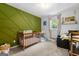 bedroom with green accent wall, carpeted floor, wooden crib and bright natural light at 4883 Rock Haven Sw Dr, Lilburn, GA 30047