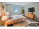 Modern staged bedroom with natural wood accents, TV, and plush rug at 2725 St Augustine Trl, Marietta, GA 30067