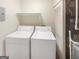 Laundry room area with washer, dryer, shelving and mechanical components at 2725 St Augustine Trl, Marietta, GA 30067