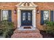 Charming brick facade featuring an elegant front door with decorative detailing and flanking windows at 3736 Bloxham Ct, Atlanta, GA 30341