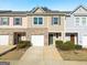 Charming exterior of a two-story townhome with a one-car garage and small front yard at 3232 Tarian Way, Decatur, GA 30034