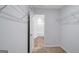 Walk-in closet leads to bathroom featuring carpeted floor and white wire shelving at 3232 Tarian Way, Decatur, GA 30034