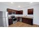 Modern kitchen with stainless steel appliances, granite countertops, and dark wood cabinets at 3232 Tarian Way, Decatur, GA 30034