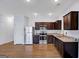 Open kitchen features granite countertops, stainless steel appliances, and wood floors at 3232 Tarian Way, Decatur, GA 30034