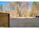 A fenced-in backyard with a well-maintained lawn and mature trees in the background at 3232 Tarian Way, Decatur, GA 30034