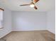 Cozy bedroom features neutral carpet, a ceiling fan, and large window at 3232 Tarian Way, Decatur, GA 30034