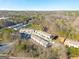An aerial view of a neighborhood showcasing the community layout surrounded by trees at 3232 Tarian Way, Decatur, GA 30034