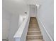 Carpeted stairway with white banister and neutral walls at 3232 Tarian Way, Decatur, GA 30034