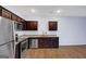 Modern kitchen features stainless steel appliances, granite countertops, and dark wood cabinetry at 3232 Tarian Way, Decatur, GA 30034
