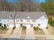 An eye-level exterior view of townhomes with manicured lawns and attached garages at 3232 Tarian Way, Decatur, GA 30034