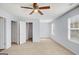 Bright bedroom with ceiling fan, two windows, and a walk-in closet at 3232 Tarian Way, Decatur, GA 30034
