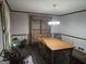 Dining room featuring a light fixture, dining table and chairs, a wooden hutch and wood floors at 430 Sweetgum Dr, Woodstock, GA 30188