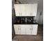 Kitchen featuring modern appliances, dark countertops, and white cabinets at 1631 Royal Ives Dr, Lawrenceville, GA 30045