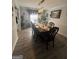 Spacious dining room with hardwood floors, stylish lighting, and seating for eight at 1631 Royal Ives Dr, Lawrenceville, GA 30045