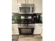 Updated kitchen with stainless steel range, black backsplash, and plenty of counter space at 1631 Royal Ives Dr, Lawrenceville, GA 30045