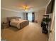 Relaxing main bedroom featuring a neutral color palette, ceiling fan, and private television at 1631 Royal Ives Dr, Lawrenceville, GA 30045