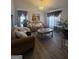 Bright living room featuring hardwood floors, stylish furniture, and elegant decor at 1631 Royal Ives Dr, Lawrenceville, GA 30045