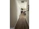 Hallway leading to a bright living area, hardwood floors, and neutral paint at 1631 Royal Ives Dr, Lawrenceville, GA 30045