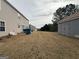 A view of the backyard with grass, a shed, and the side of the house visible at 1631 Royal Ives Dr, Lawrenceville, GA 30045