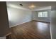 Bedroom featuring neutral paint, updated lighting, and wood-look flooring at 3814 Kensingwood Trce, Decatur, GA 30032