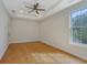 Bright bedroom with tray ceiling, ceiling fan, and a large window at 553 Sommersby Dr, Dallas, GA 30157