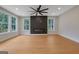 Bright living room with wood floors, an electric fireplace, recessed lighting, and large windows at 553 Sommersby Dr, Dallas, GA 30157