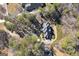 An aerial view of a home showcasing its roofline and surroundings with mature trees at 2009 Pine Forest Ct, Jonesboro, GA 30236