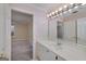 Well-lit bathroom featuring a large mirror, vanity with sink, and view to the bedroom at 2009 Pine Forest Ct, Jonesboro, GA 30236