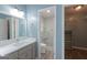 Clean bathroom featuring a vanity, modern lighting, and a walk-in shower with glass door at 120 Wisteria Ct, Tyrone, GA 30290