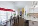 Dining area next to the kitchen with hardwood floors and natural light at 120 Wisteria Ct, Tyrone, GA 30290