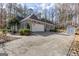 Side view of a charming single Gathering home with a long driveway, garage and storage shed at 120 Wisteria Ct, Tyrone, GA 30290