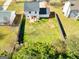 Aerial view of the property showing the spacious backyard, fence line, and neighboring homes at 261 Whistle Way, Locust Grove, GA 30248