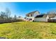 Spacious, well-maintained backyard featuring a large grassy area and a privacy fence at 261 Whistle Way, Locust Grove, GA 30248