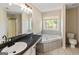 Large bathroom with a soaking tub and dual vanities at 261 Whistle Way, Locust Grove, GA 30248