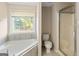 Bright bathroom featuring soaking tub and separate shower at 261 Whistle Way, Locust Grove, GA 30248