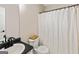 Simple bathroom featuring a sink, toilet, and shower with a curtain, offering functionality and cleanliness at 261 Whistle Way, Locust Grove, GA 30248