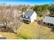 Two story home with a long driveway, red shutters, neutral siding, and manicured landscaping at 261 Whistle Way, Locust Grove, GA 30248