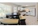 Open eat-in kitchen with white cabinetry, tiled floor, and natural light at 261 Whistle Way, Locust Grove, GA 30248