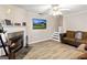 Cozy living room features a fireplace, stylish flooring, comfortable seating, and a modern television at 261 Whistle Way, Locust Grove, GA 30248
