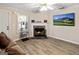 Cozy living room features a fireplace, stylish flooring, comfortable seating, and a modern television at 261 Whistle Way, Locust Grove, GA 30248