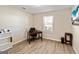 Bright office space with a window, hardwood floors, a desk, and neutral walls at 261 Whistle Way, Locust Grove, GA 30248