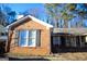 Charming brick home featuring a classic design, complemented by surrounding trees and a blue sky backdrop at 1899 Se Cooper Landing Se Dr, Smyrna, GA 30080